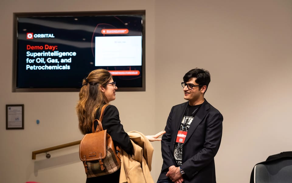 Dr Samyakh Tukra, co-founder and chief AI officer of Applied Computing, talking with a guest at the company’s 2025 demo day in London