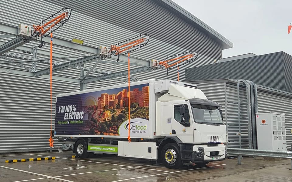 A Bidfood electric truck parked under the overhead charging gantry at the company’s Slough depot