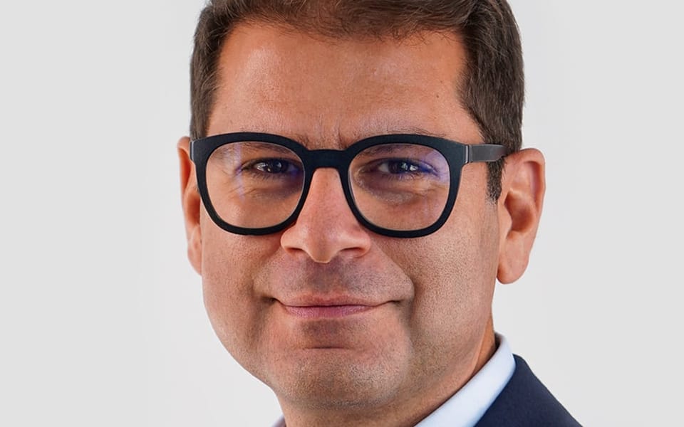 Gilbert Verdian, founder and CEO of Quant, in a head-and-shoulders portrait wearing glasses and a navy jacket