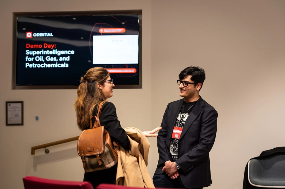 Dr Samyakh Tukra, co-founder and chief AI officer of Applied Computing, talking with a guest at the company’s 2025 demo day in London
