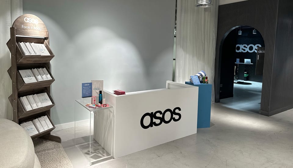 An ASOS Face + Body event space with a branded reception desk