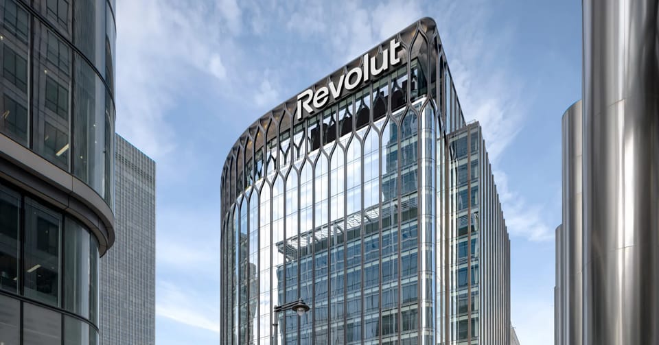 Revolut's headquarters building in Canary Wharf, London, with the company's name on its roof