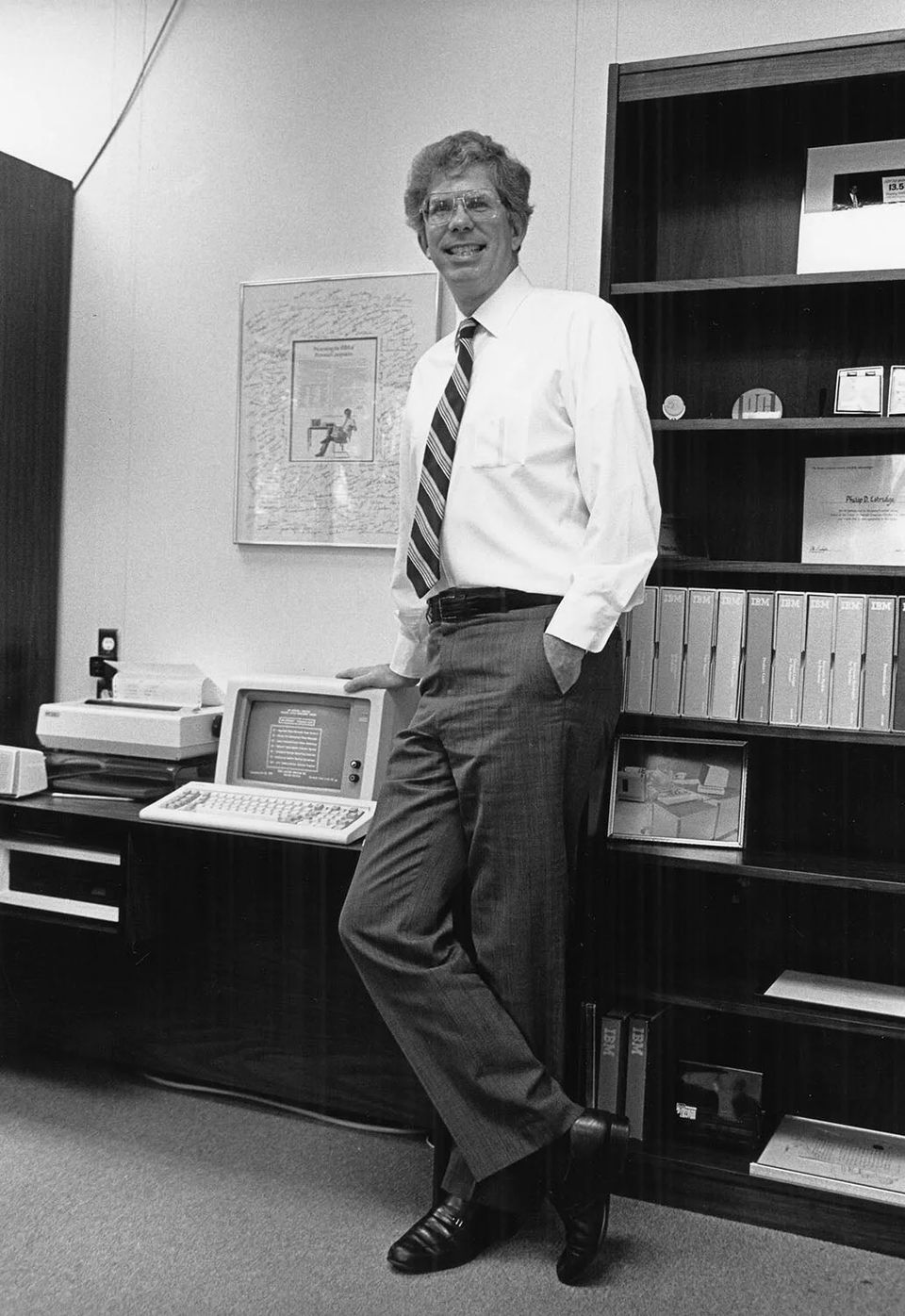 Don Estridge, who led the IBM PC project, leaning on a desk beside an IBM PC