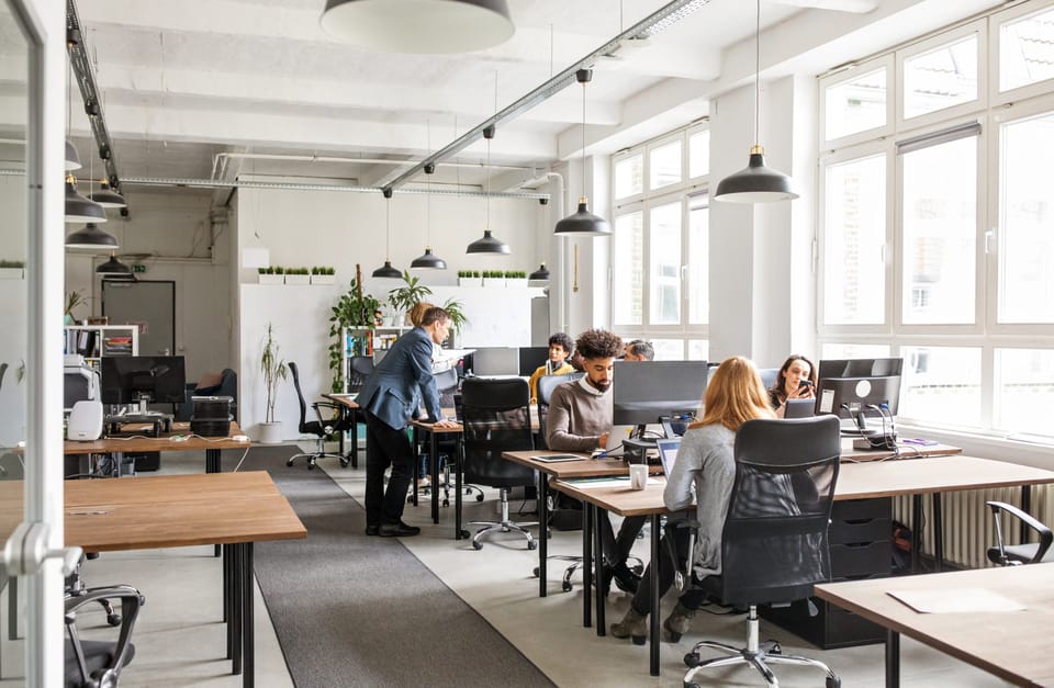 Colleagues working at desks in an open-plan office