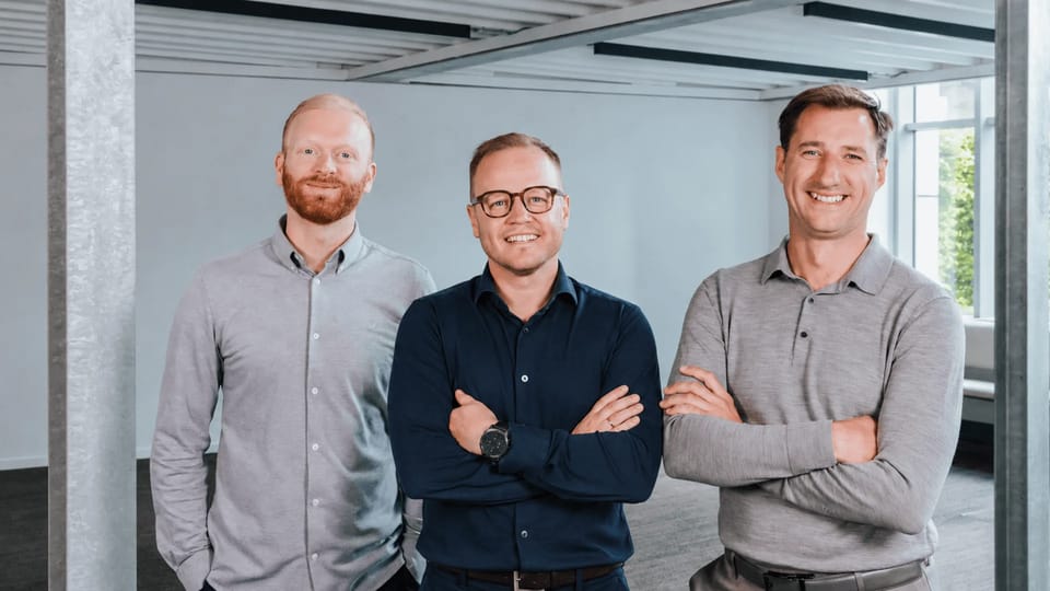 Ravical's three co-founders standing together indoors