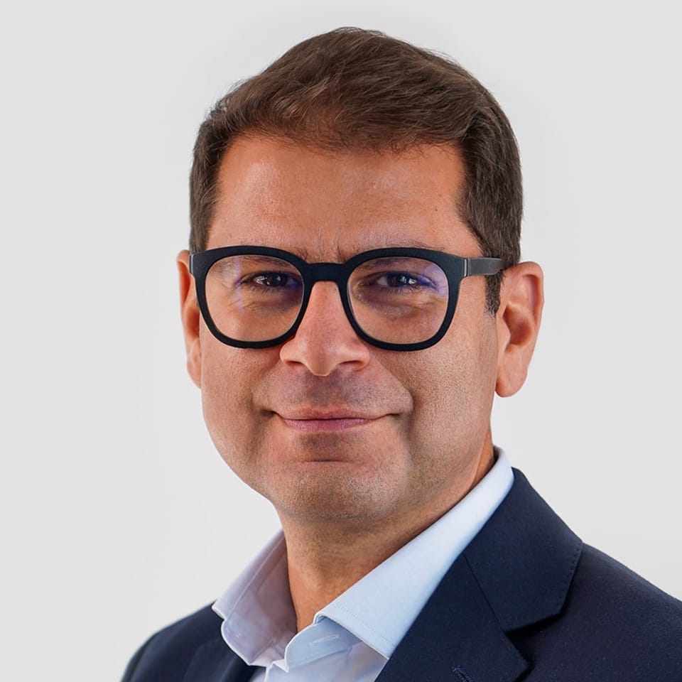 Gilbert Verdian, founder and CEO of Quant, in a head-and-shoulders portrait wearing glasses and a navy jacket