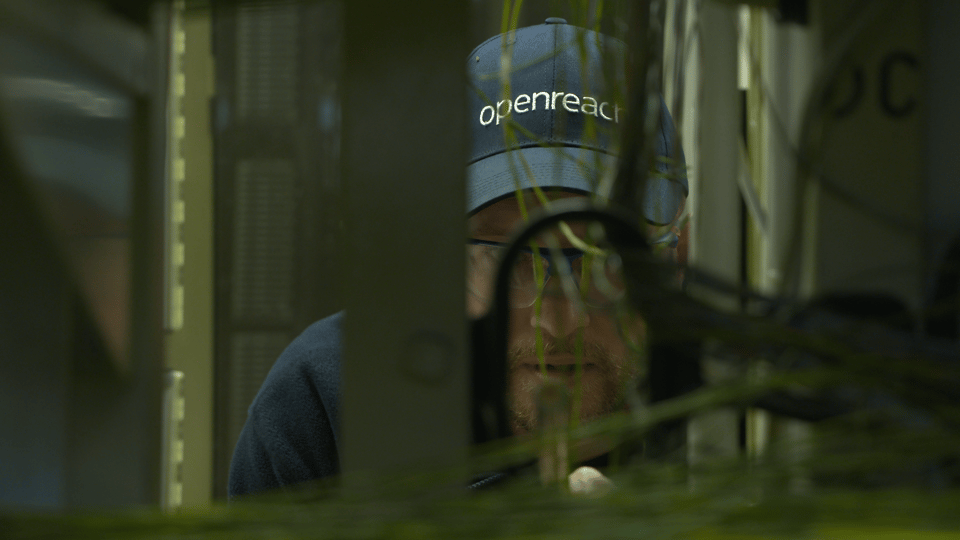 An Openreach engineer working on equipment in a copper telephone exchange